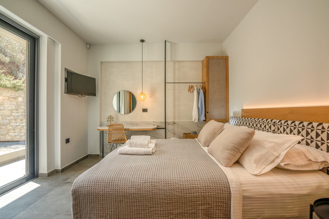 Comfortable twin bedroom with matching beds, geometric headboards, and modern lighting at Nusa Gramvousa villa in Kissamos, Crete