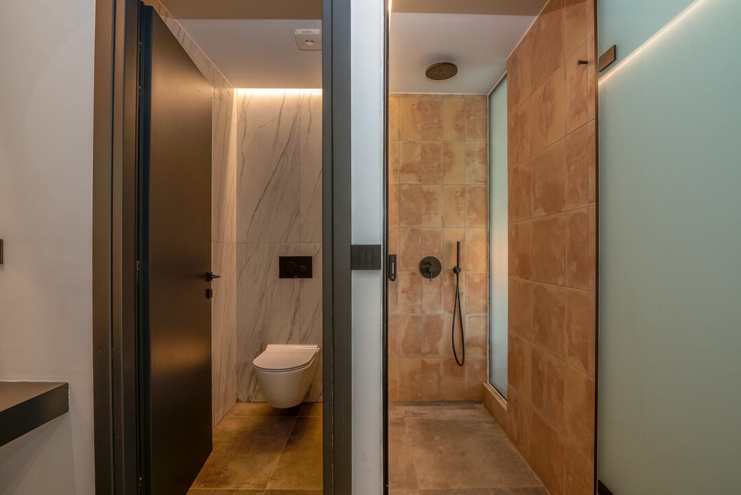 Functional dressing area with hanging rail, storage shelf, and access to en-suite at Nusa Gramvousa villa, Crete