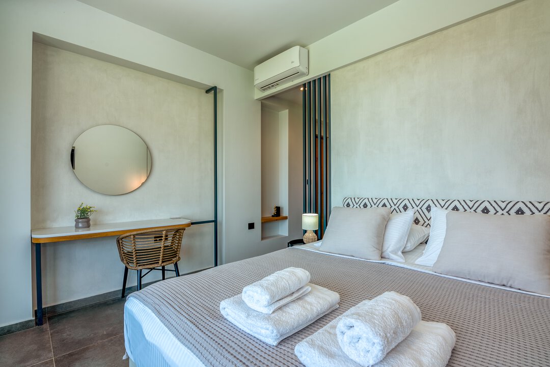 Modern toilet area with wall-hung WC, marble cladding, and minimalist design at Nusa Gramvousa, Crete