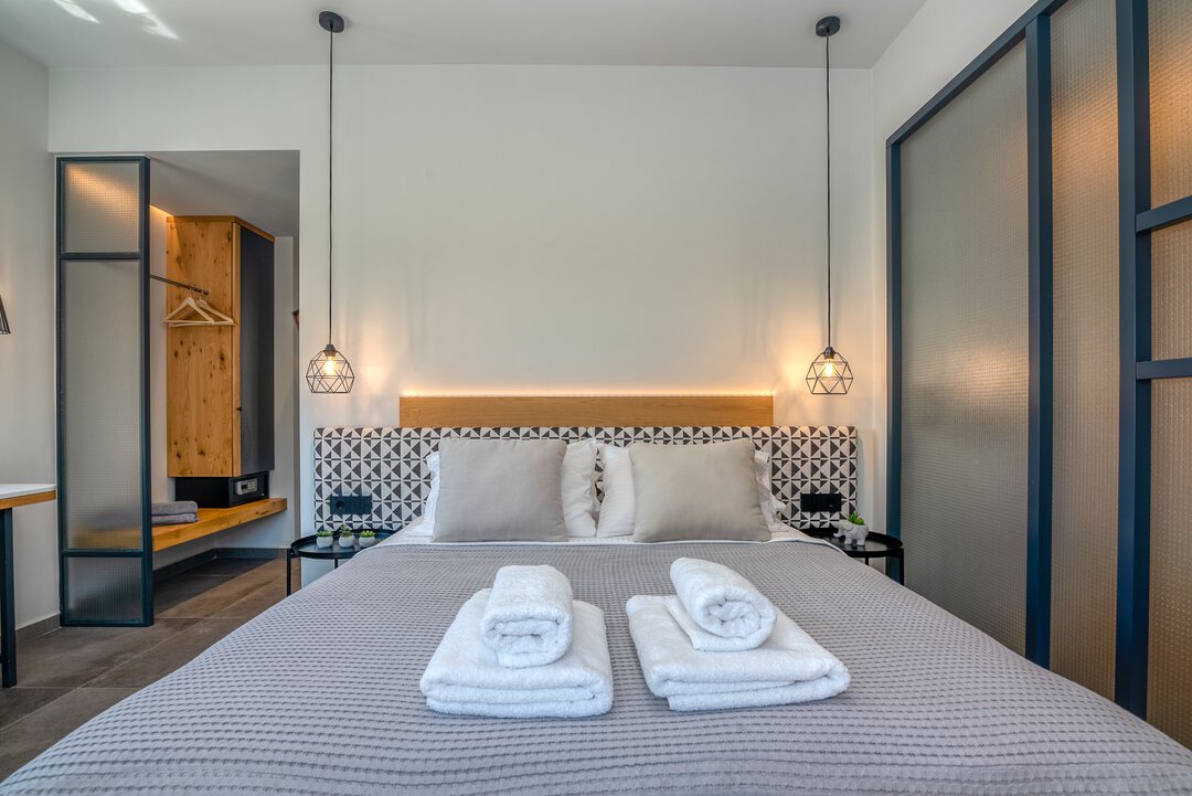 Stylish bedroom combining modern comfort with Mediterranean charm at Nusa Falassarna villa, Crete