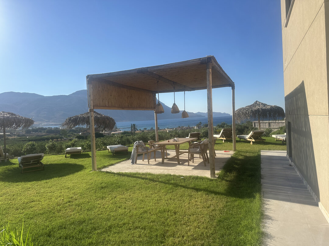 NUSA Balos outdoor terraces, pool, and pergola spaces